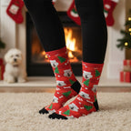 Red Christmas custom dog socks with a pet in a Santa hat print, worn at home with a small white dog nearby