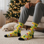 Yellow Christmas custom dog socks with a pet in a Santa hat print, worn at home with a small white dog nearby